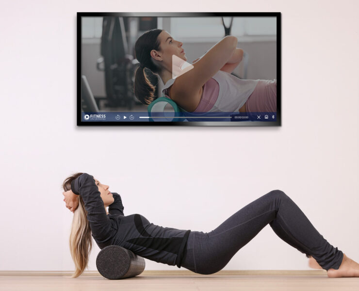 woman doing crunches while looking at TV screen