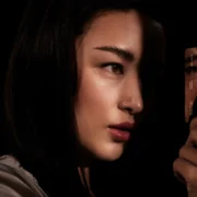 A woman staring at the Atlas credit card in her hand.