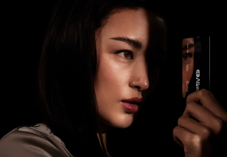 A woman staring at the Atlas credit card in her hand.
