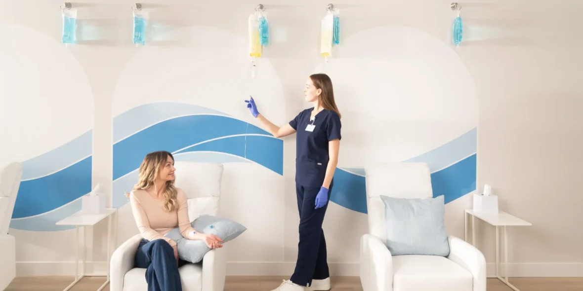 A Hydration Room guest getting an IV administered by a woman.