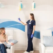 A Hydration Room guest getting an IV administered by a woman.
