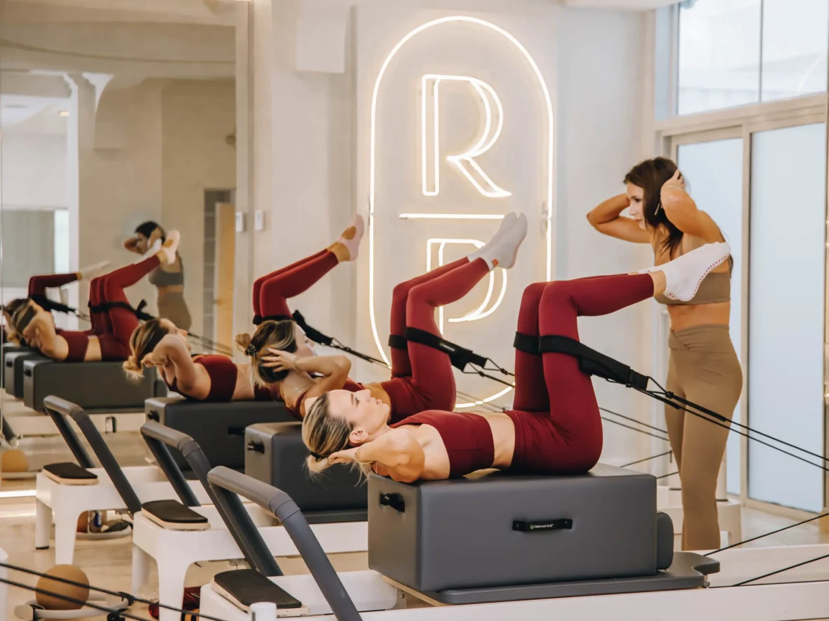 A class at Reforming Pilates with women using Reformers.