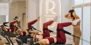 A class at Reforming Pilates with women using Reformers.