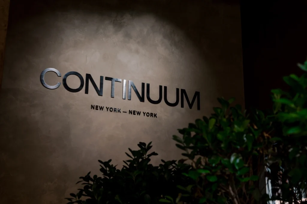 Continuum Club logo on a stone wall inside the club