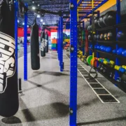 punching bag and power racks inside a Crunch Fitness gym