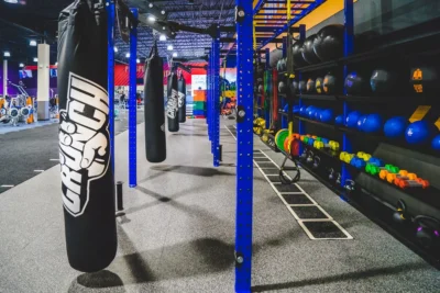 punching bag and power racks inside a Crunch Fitness gym