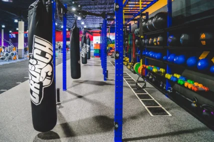 punching bag and power racks inside a Crunch Fitness gym
