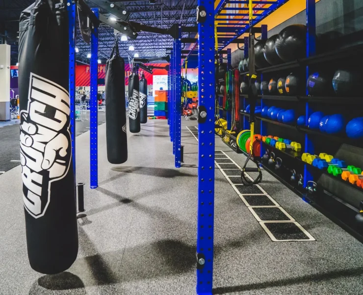 punching bag and power racks inside a Crunch Fitness gym