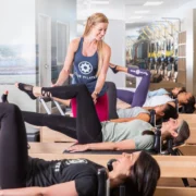 instructor helps a client at a Club Pilates