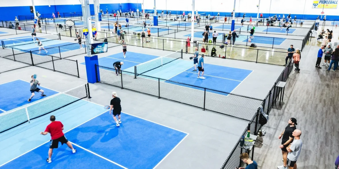 The interior of a Pickleball Kingdom and people playing together.