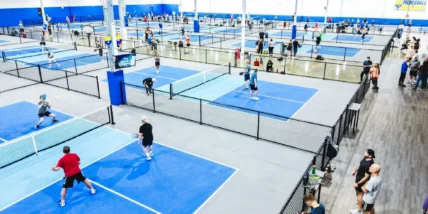 The interior of a Pickleball Kingdom and people playing together.