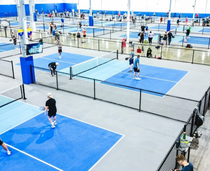 The interior of a Pickleball Kingdom and people playing together.