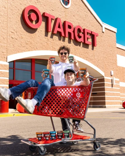 Protein Pints founders in a shopping cart outside of a Target store.