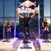 indoor cycling class inside a New York City studio adorned with a Red Bull logo