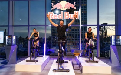 indoor cycling class inside a New York City studio adorned with a Red Bull logo