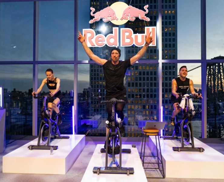 indoor cycling class inside a New York City studio adorned with a Red Bull logo