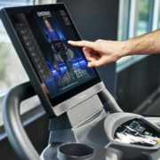 closeup of man touching Echelon treadmill screen