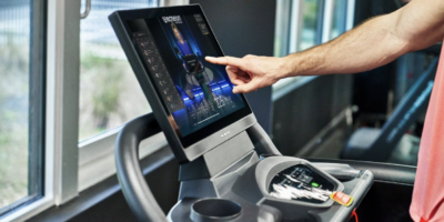 closeup of man touching Echelon treadmill screen