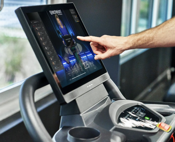 closeup of man touching Echelon treadmill screen