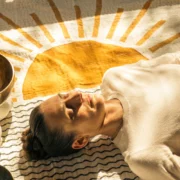 A woman experiencing a sound healing session/sound bath.