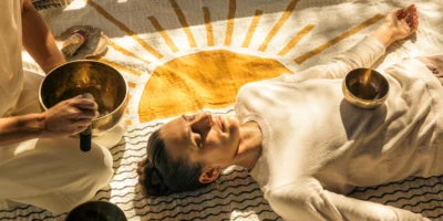 A woman experiencing a sound healing session/sound bath.