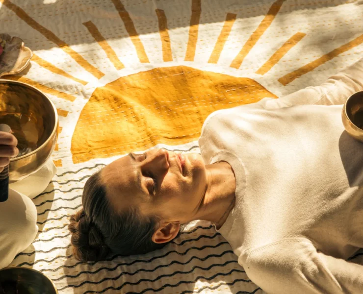 A woman experiencing a sound healing session/sound bath.