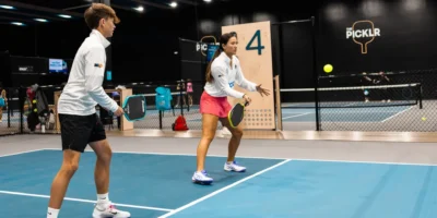 The Picklr and people playing on the court.