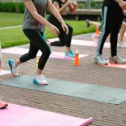 A group fitness class with people on yoga mats.