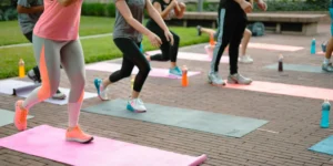 A group fitness class with people on yoga mats.