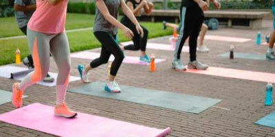 A group fitness class with people on yoga mats.
