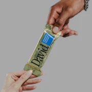 hands of a man and woman grab a David protein bar