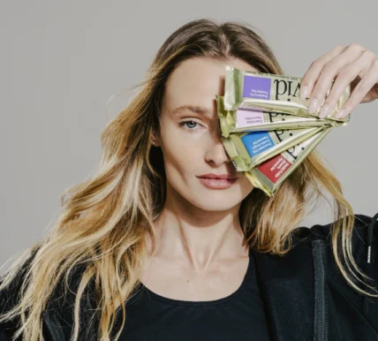 woman holds David protein bars in front of her face