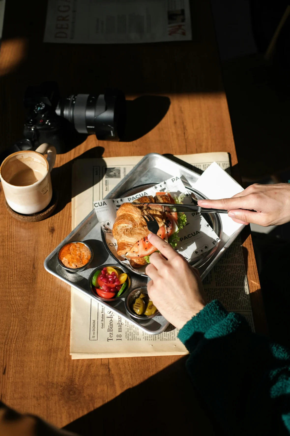 a person cutting into a croissant