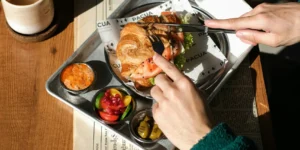 a person cutting into a croissant