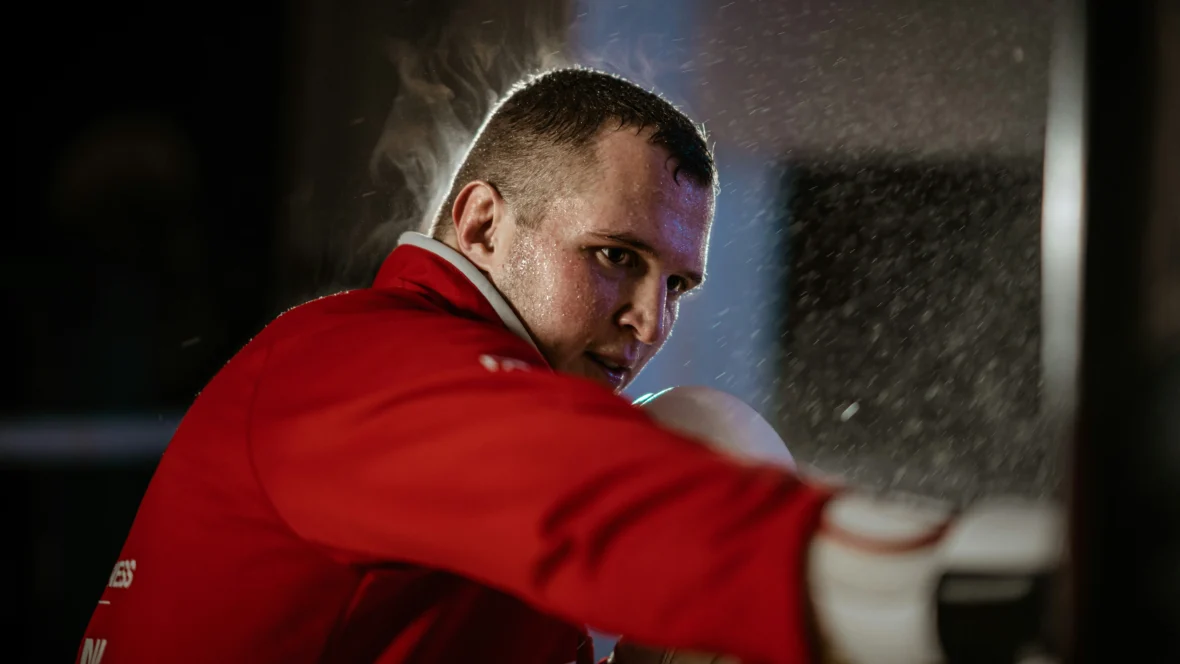 A man MMA training in a red shirt.