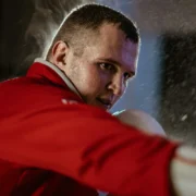 A man MMA training in a red shirt.