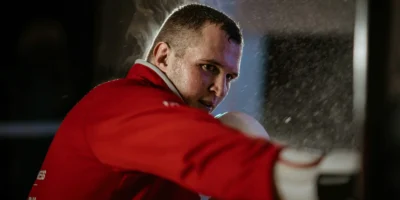 A man MMA training in a red shirt.