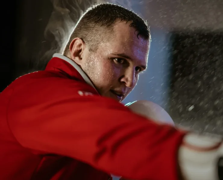A man MMA training in a red shirt.
