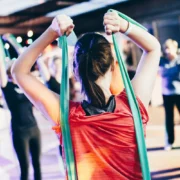 young girls in a gym class with resistance bands