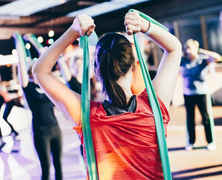 young girls in a gym class with resistance bands