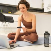 Woman using ecommerce on yoga mat