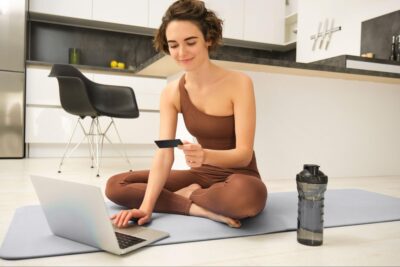 Woman using ecommerce on yoga mat