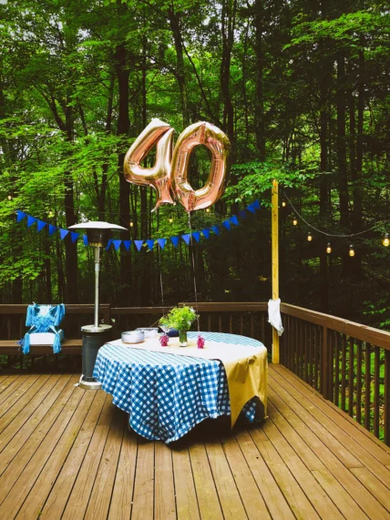 A table set up outdoors with balloons representing 40.