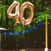 A table set up outdoors with balloons representing 40.