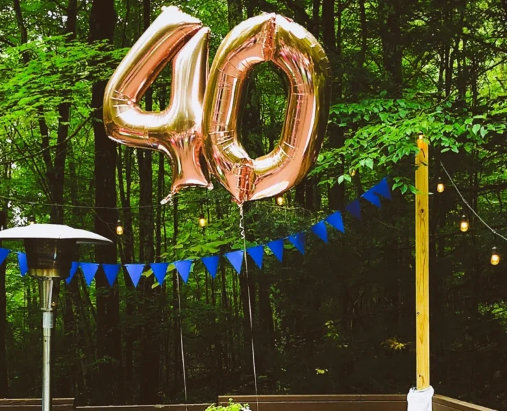A table set up outdoors with balloons representing 40.