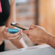 man scans his phone to enter the gym