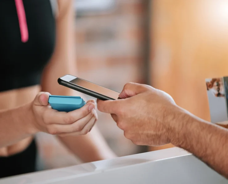 man scans his phone to enter the gym