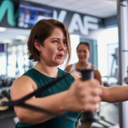 woman strength training at gym with resistance bands