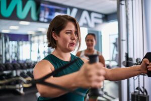 woman strength training at gym with resistance bands