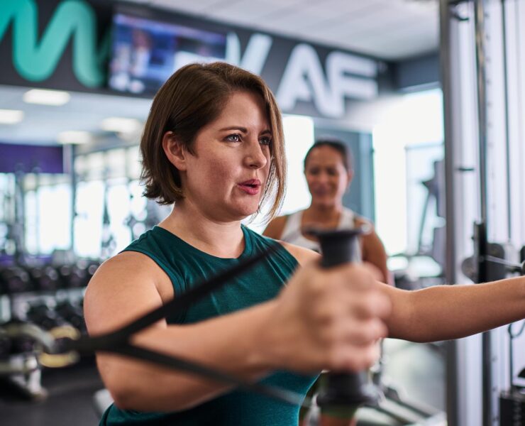 woman strength training at gym with resistance bands